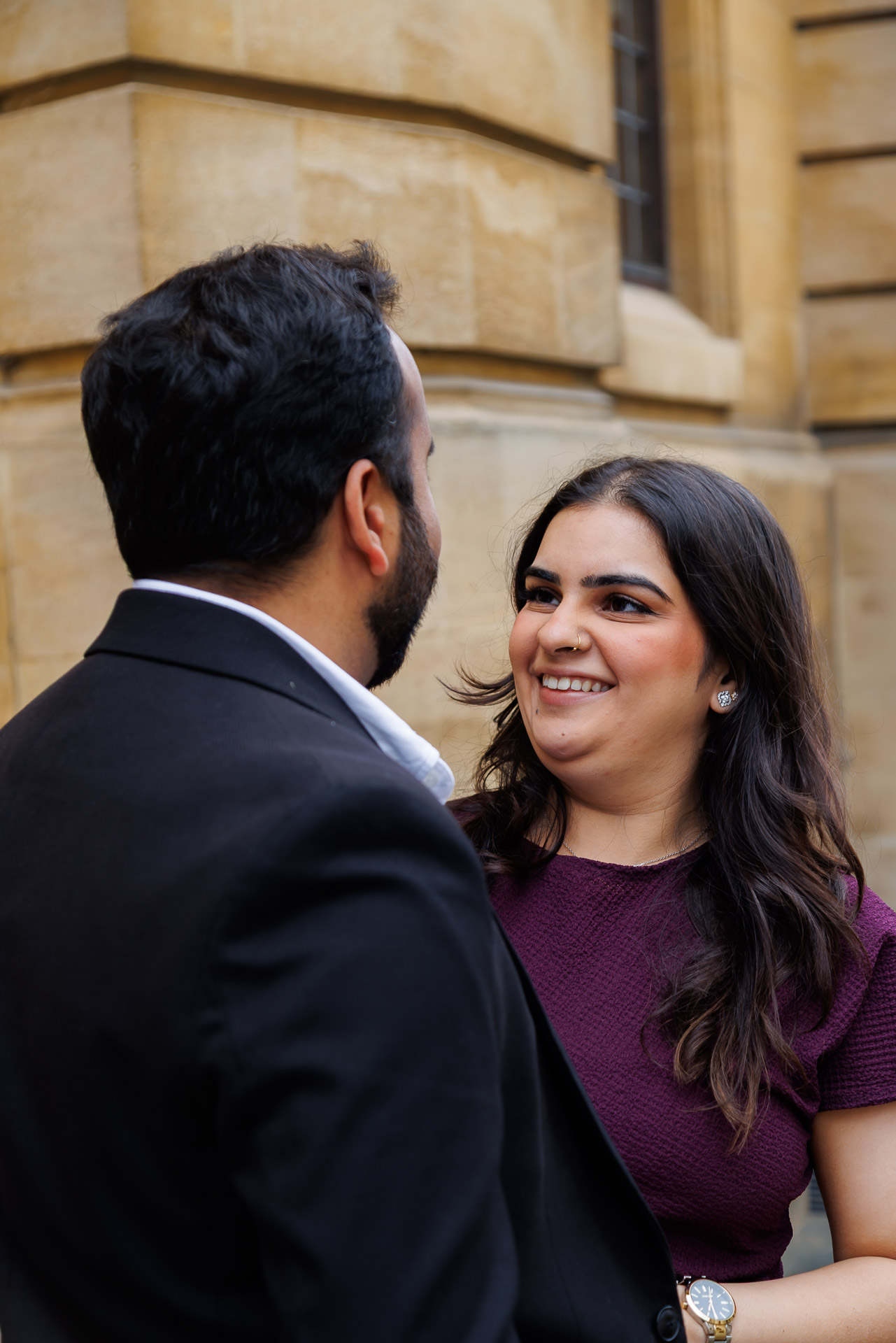 Engaged couple laughing together during Oxford University engagement photography session